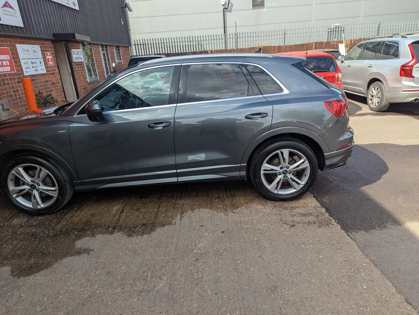 After: The same grey Audi with the rear door repaired and refinished