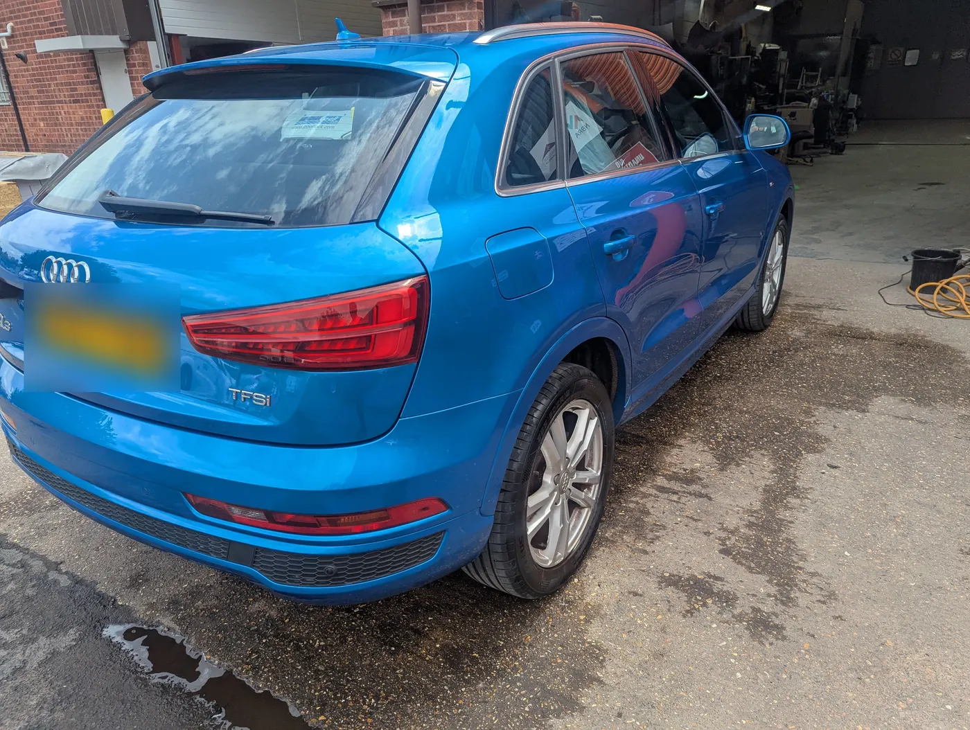 After: The same Audi Q3 with the rear corner panel repaired and resprayed