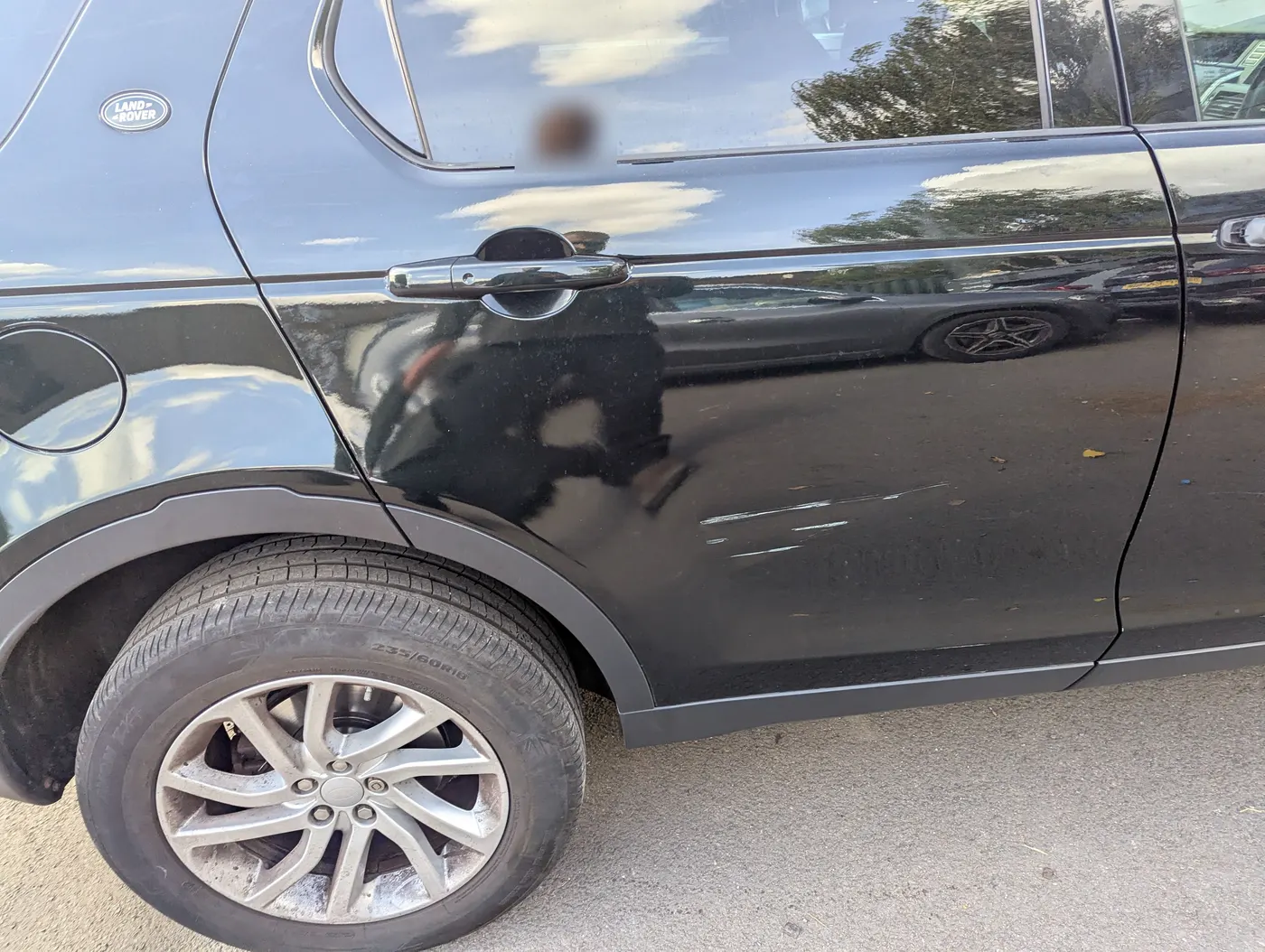 Before: Black Land Rover with scratches across the rear door